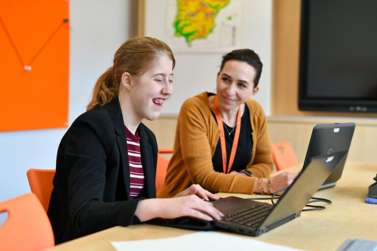 Student and Teacher studying Modern Foreign Languages with laptop