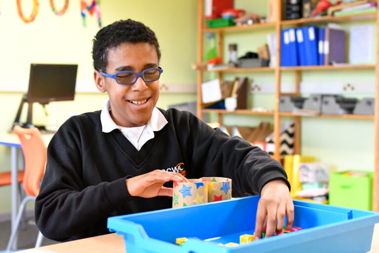 Male student with Braille Lego