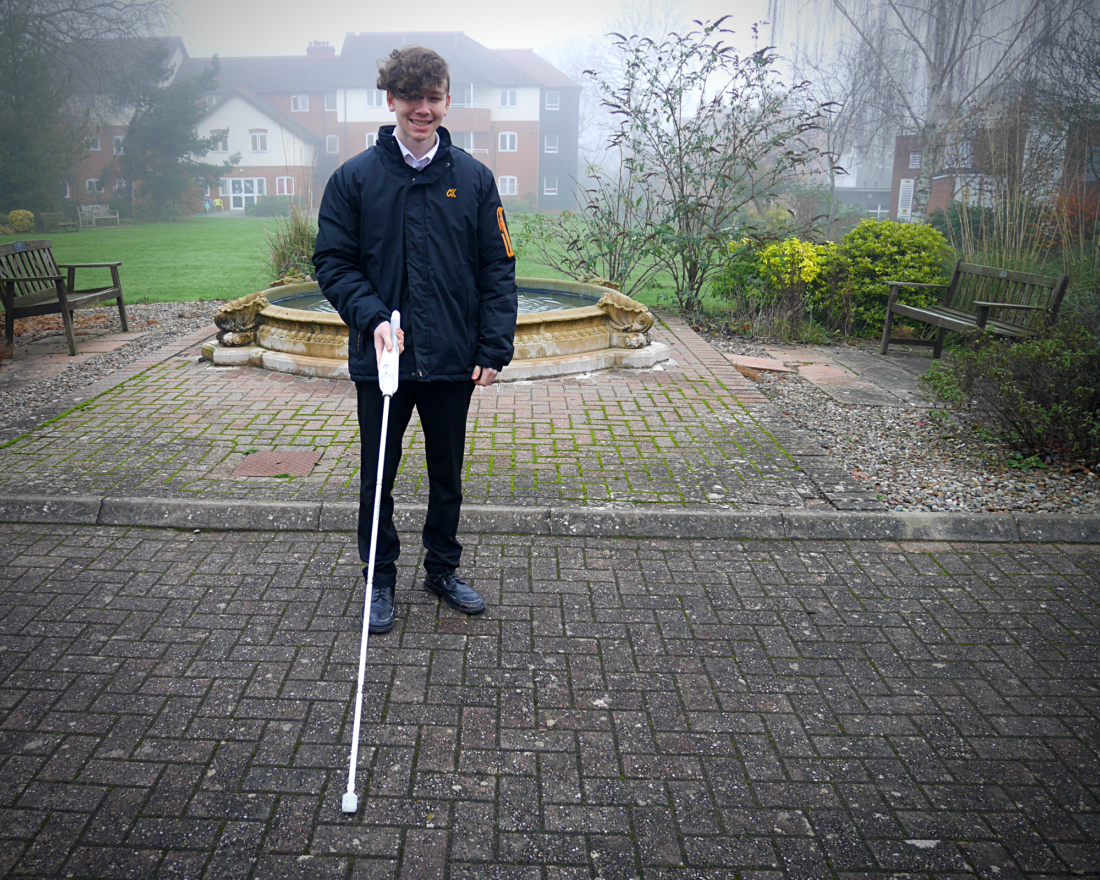 Student stood with interactive cane outside school