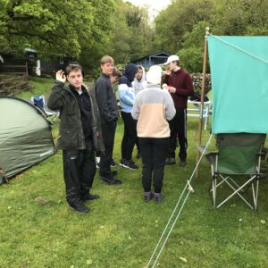 The team gathered around their tent pitch, looking glad to have some shelter!