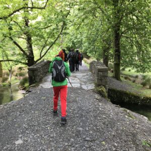 Tom W walking over a picturesque looking bridge