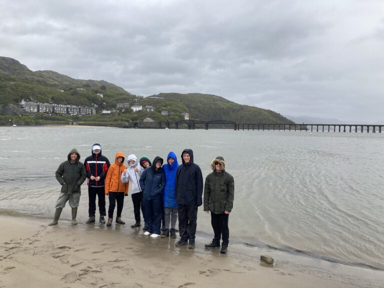 Posing for a photo at the shoreline - not looking very happy because of the weather!