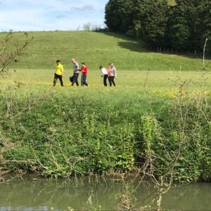 Students walking across the campsite fields