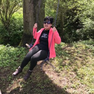 Student Rahel on a homemade tree swing