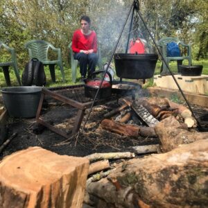 Millie sat around the camp fire