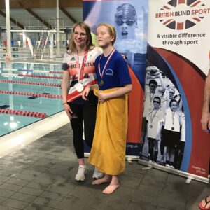 Kacey with Rebecca Redfern posing for a photo on the side of the pool