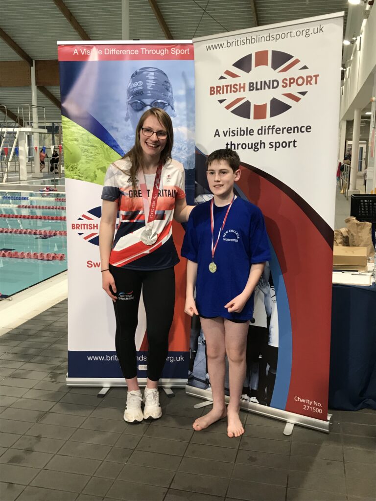 Maxwell with Rebecca Redfern posing for a photo on the side of the pool