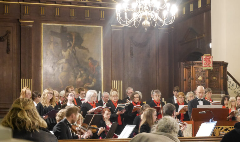 View of students along with choir mid-song in the church