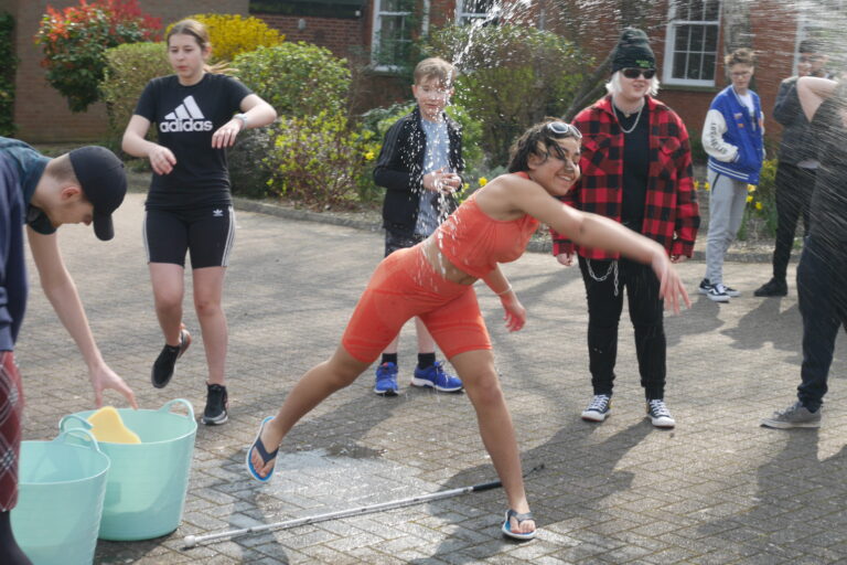 action shot of a student throwing a sponge at a teacher.