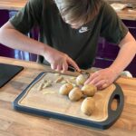 Student peeling potatoes