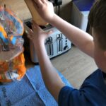 Student is putting bread in the toaster