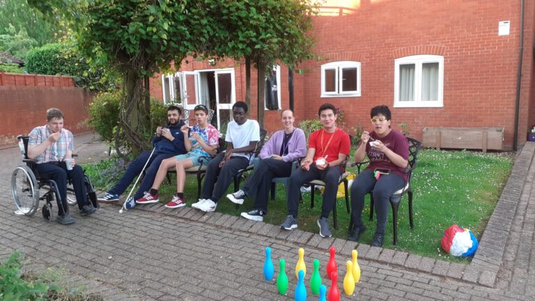 Students are relaxing with each other with pizza that DJ and Rahel made