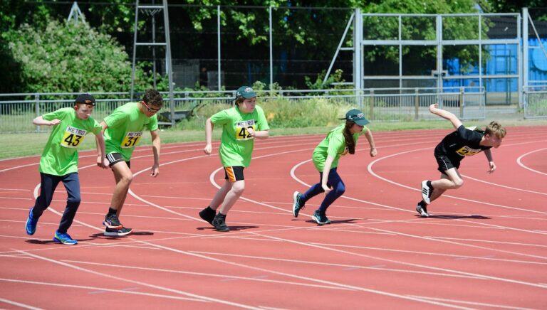 100m: Joe , Thomas W, Roman, Emma and other competitor on the track