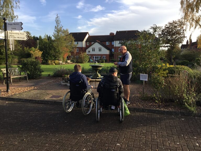 Students Toby and Corey listening to instructions from Pete about their sensory walak