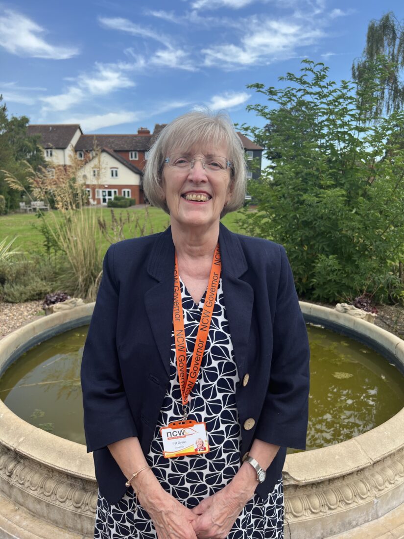 image of Pat smiling at the camera by the fountain at NCW.