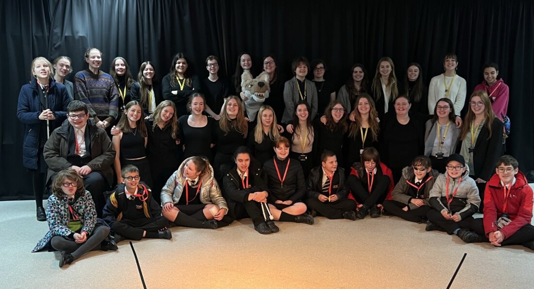 Group photo in a theatre of all students and staff involved in the event