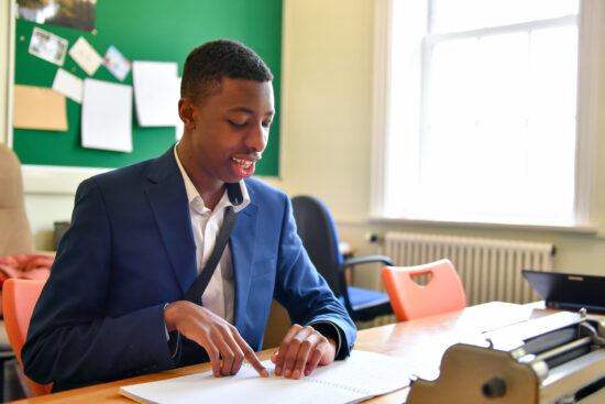 image of a sixth form student reading braille