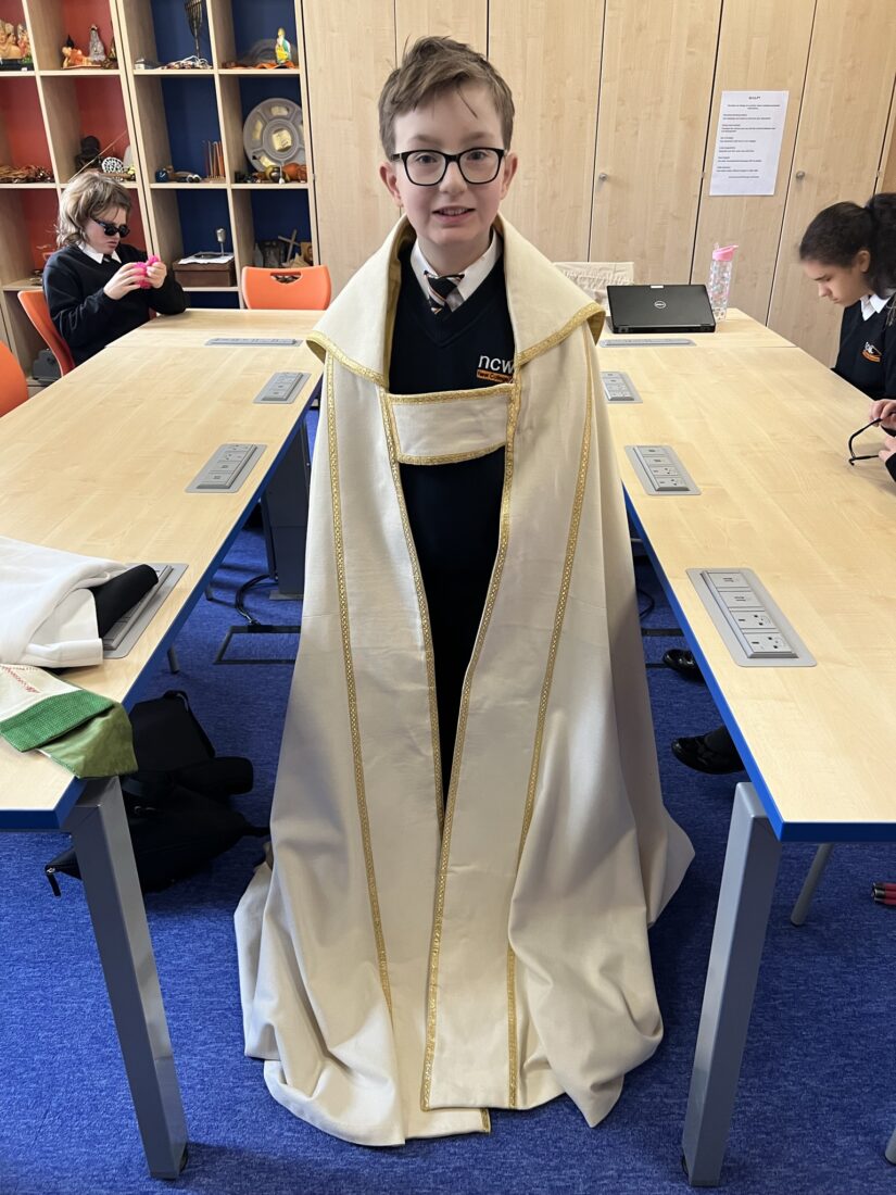 image of a student wearing a religious robe that a vicar might wear