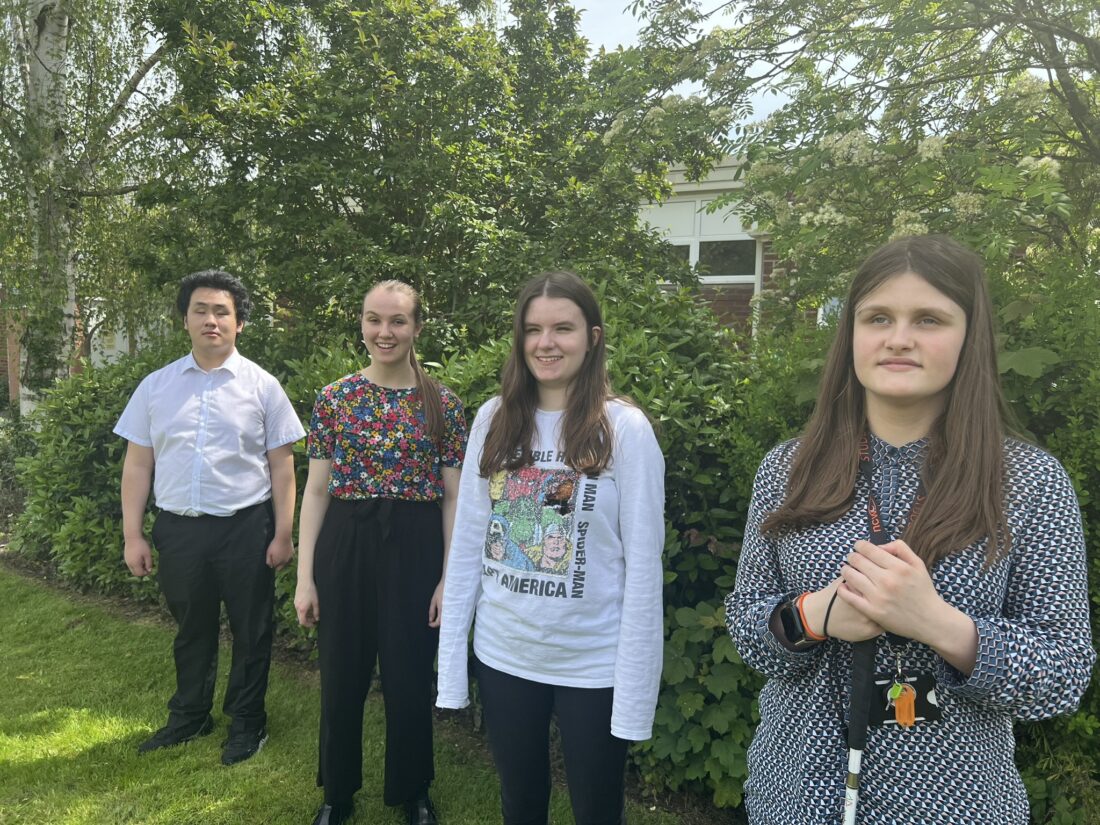 image of all four students on the lawn