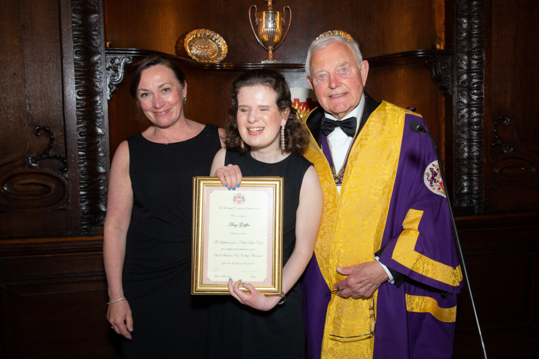 Image of Amy , Mrs Ward and a member of the Company smiling whilst Amy is holding a certificate