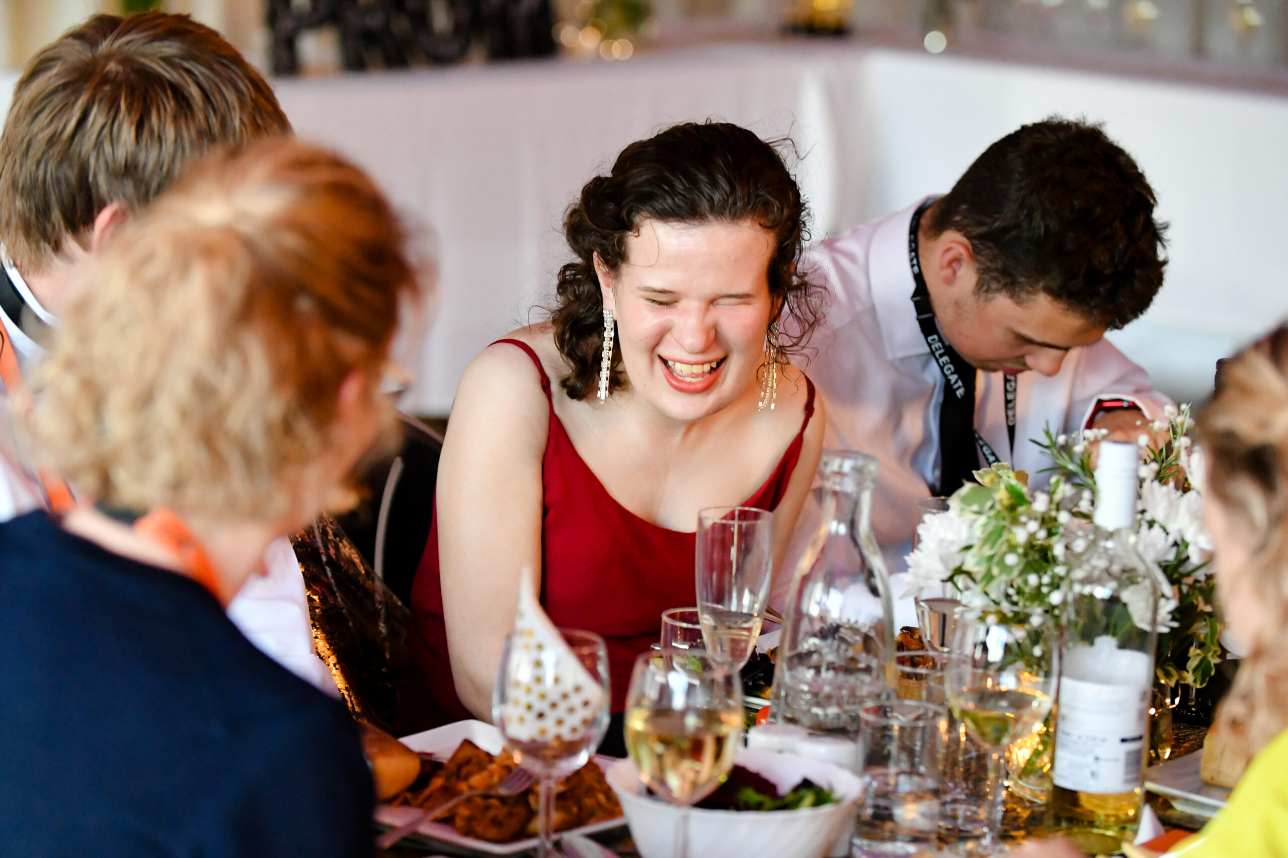 photo of a student smiling whilst sat at the table