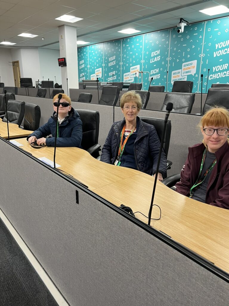 Image of Mrs Barter and two students sat behind a desk