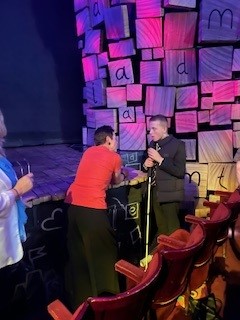 At the foot of the stage, a photograph of Jamie talking to Tia Fisher, winner of the shadower's medal for writing after the ceremony.