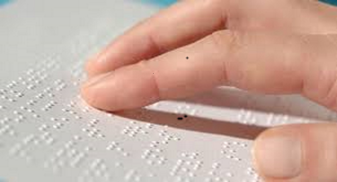 Fingers on a page reading braille music