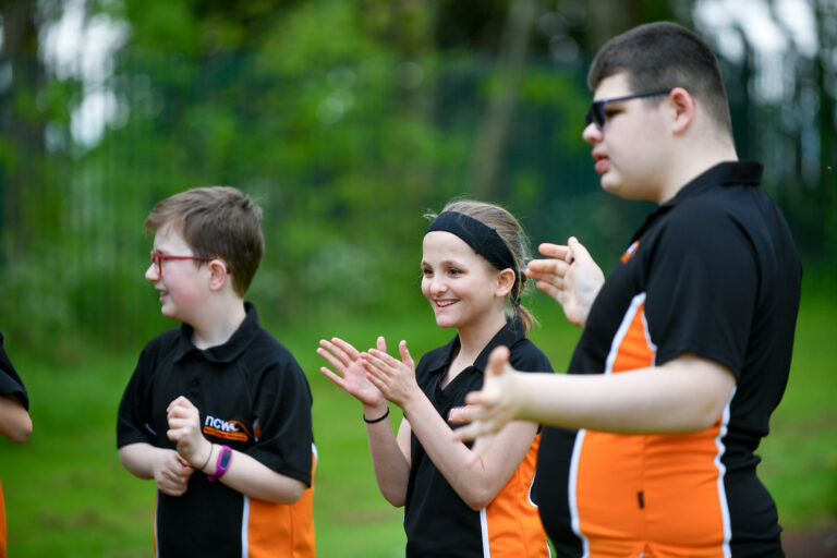 image of three students enjoying a sports session