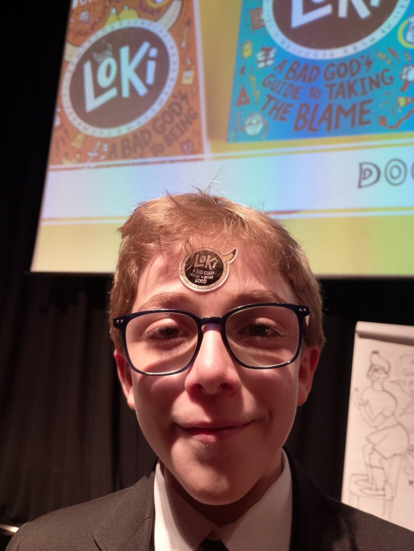 image of Zaki smiling with a sticker on his forehead