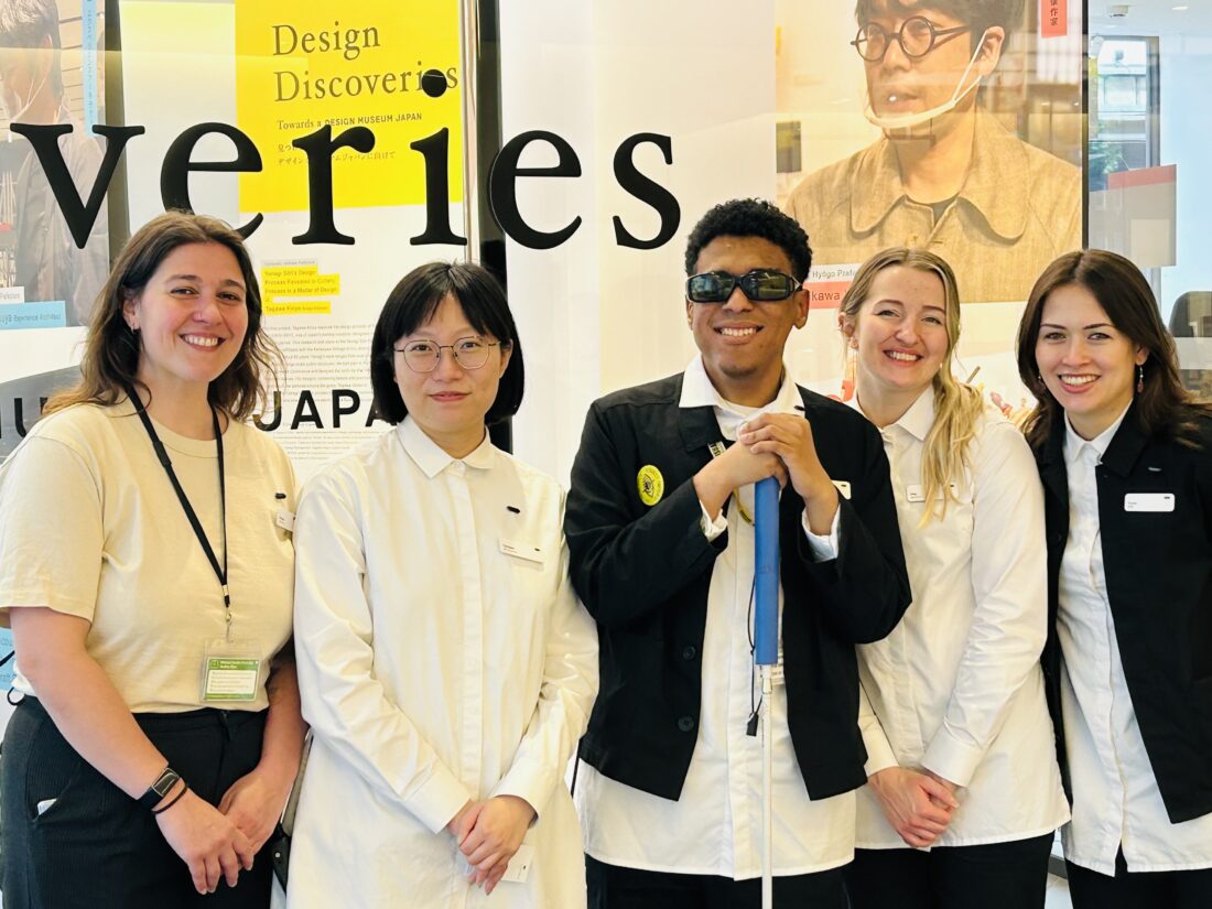 Alejandro standing in the middle with his manager (far left) and part of his team. The are standing in front of the main exhibit named Design Discoveries.