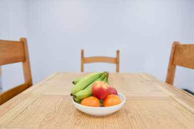 photograph of a bowl of fruit on the table.