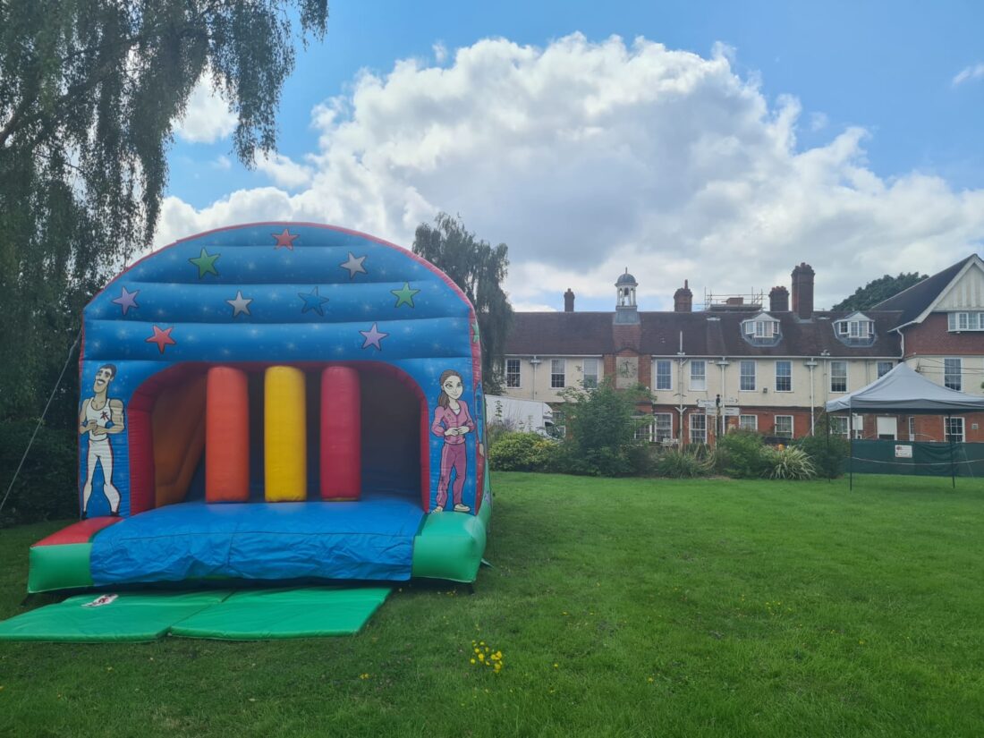 Image shows a bouncy castle fun run on a field