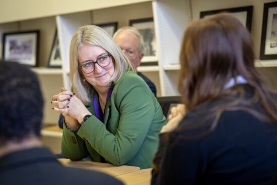 Photo of the minister talking to students and smiling